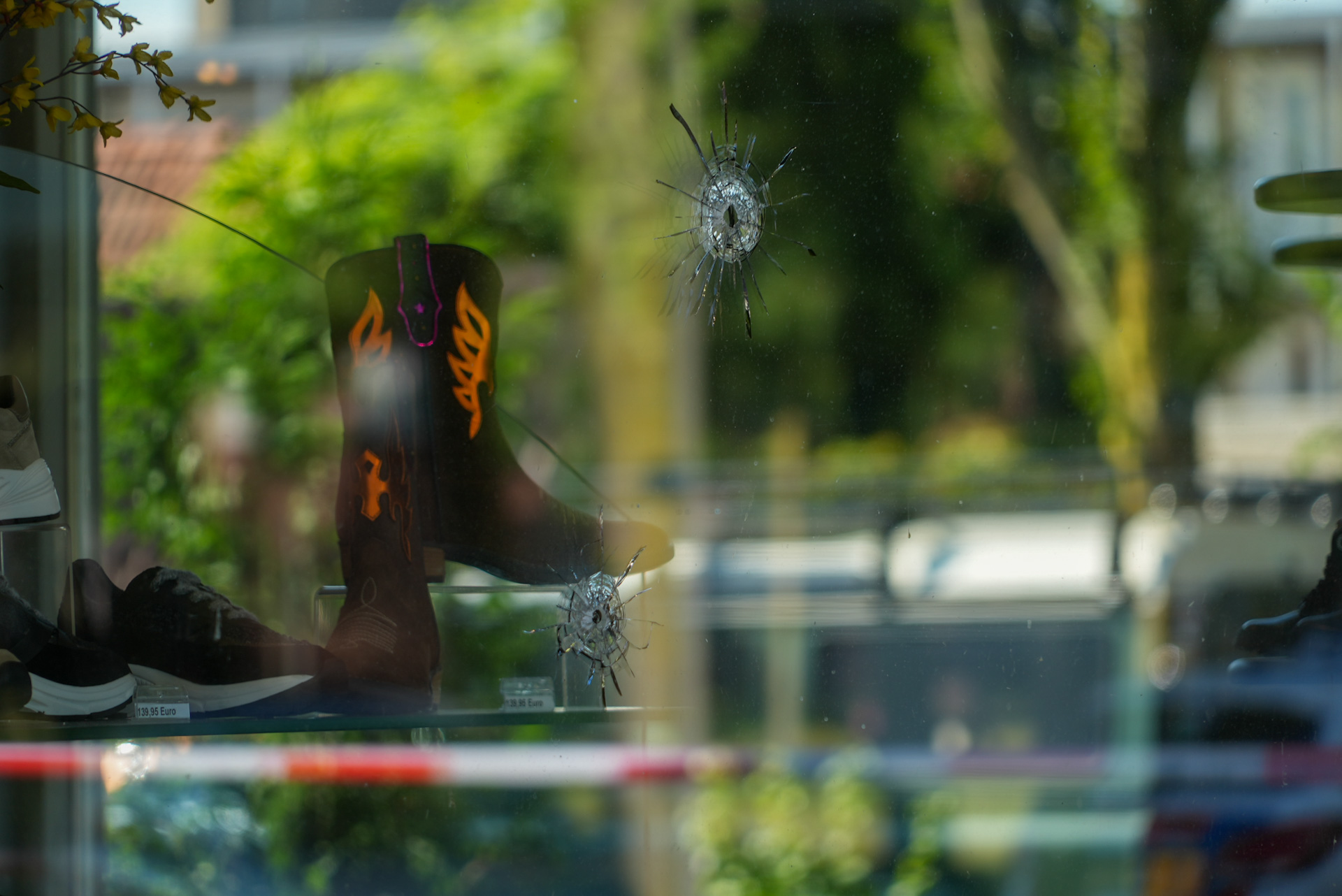 Schoenenwinkel beschoten, meerdere kogelgaten in ramen