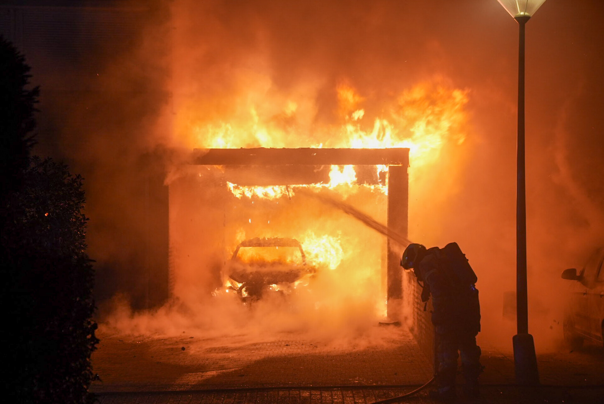 Buurtbewoner redt slapende bewoners na auto en carportbrand