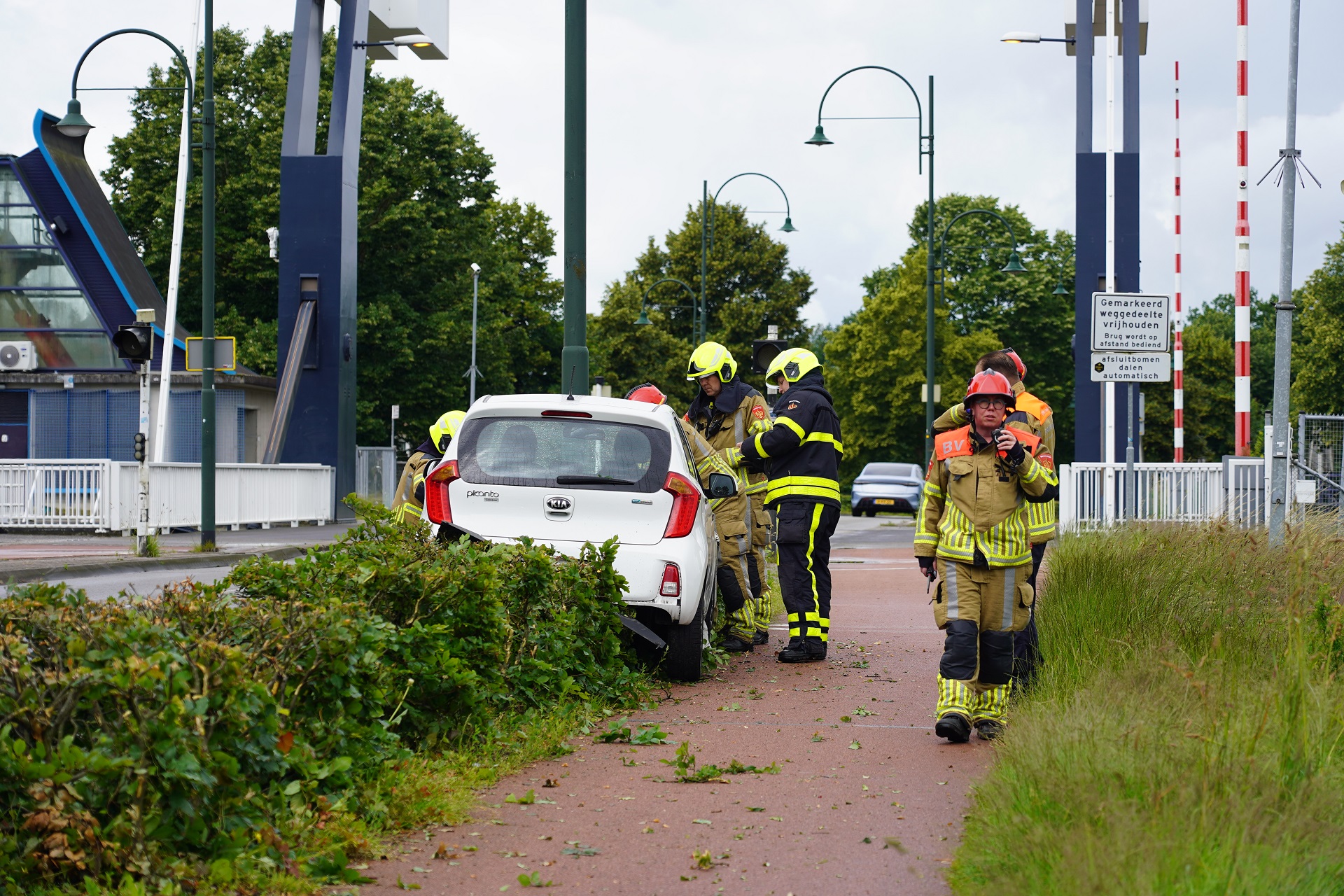 Automobilist rijdt 20 meter door de bosjes en botst tegen lantaarnpaal