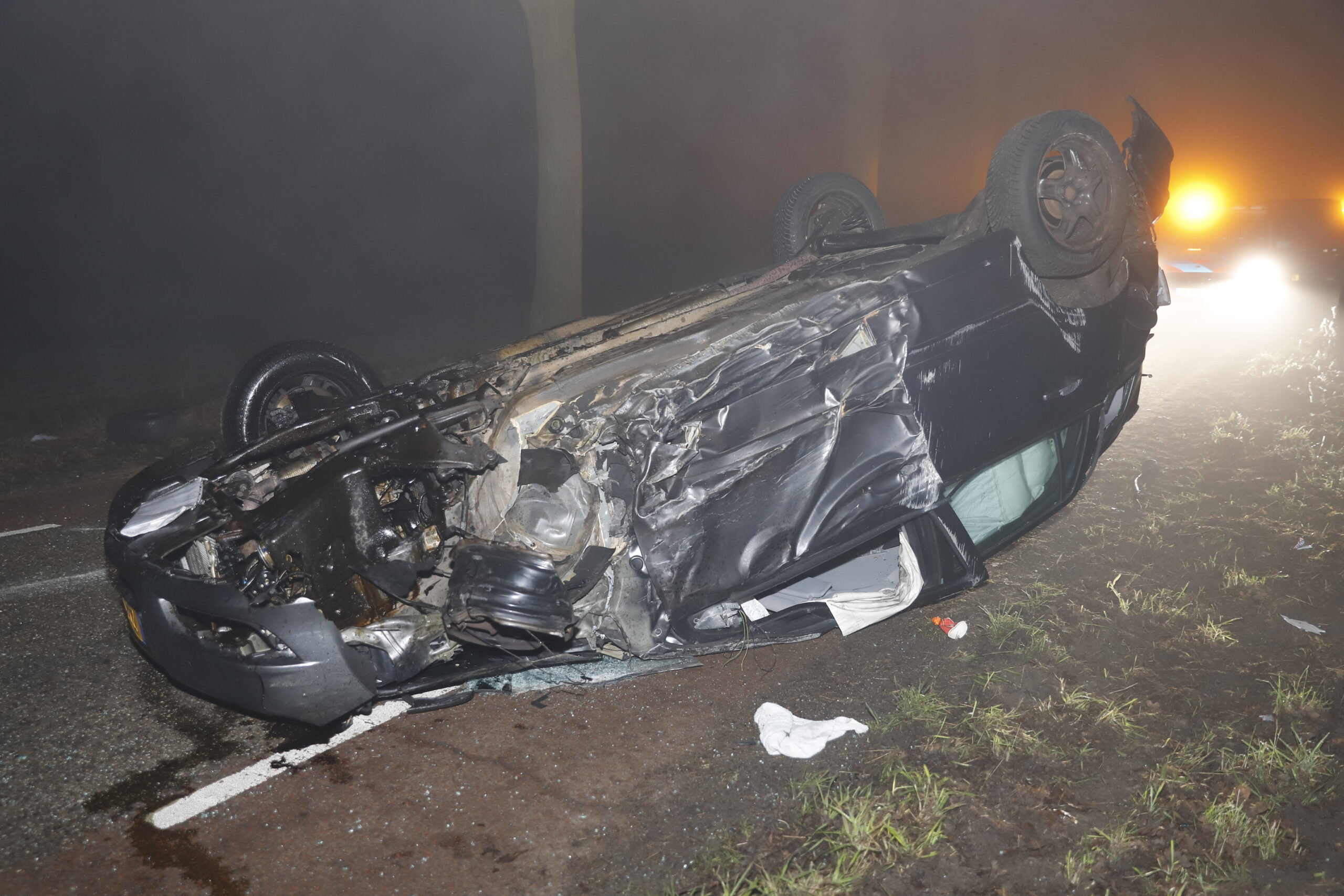 Auto vliegt over de kop en botsing tegen boom, bestuurder wandelt naar huis