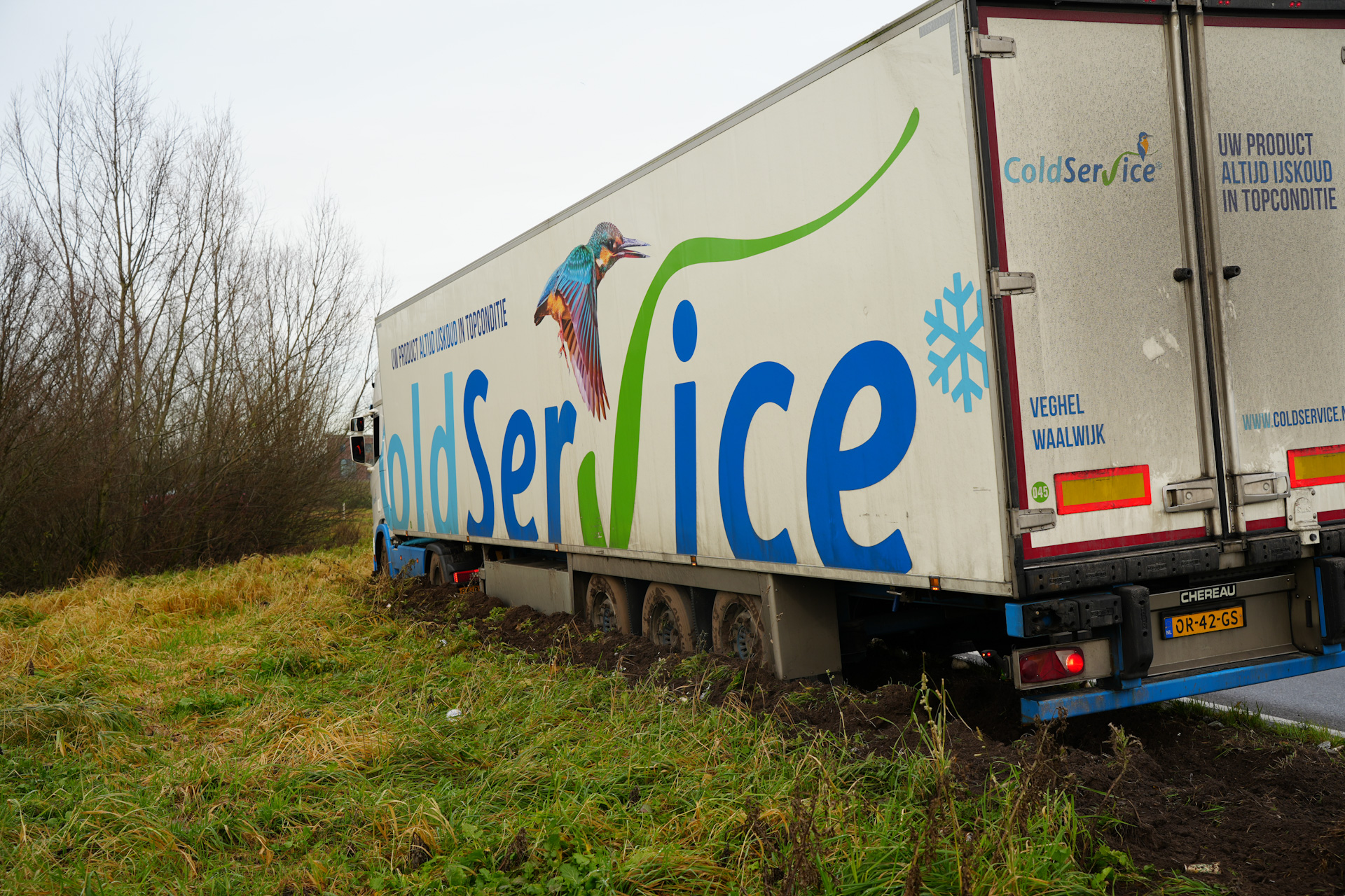 Vrachtwagen geladen met 23 pallets hamburgers vast in berm