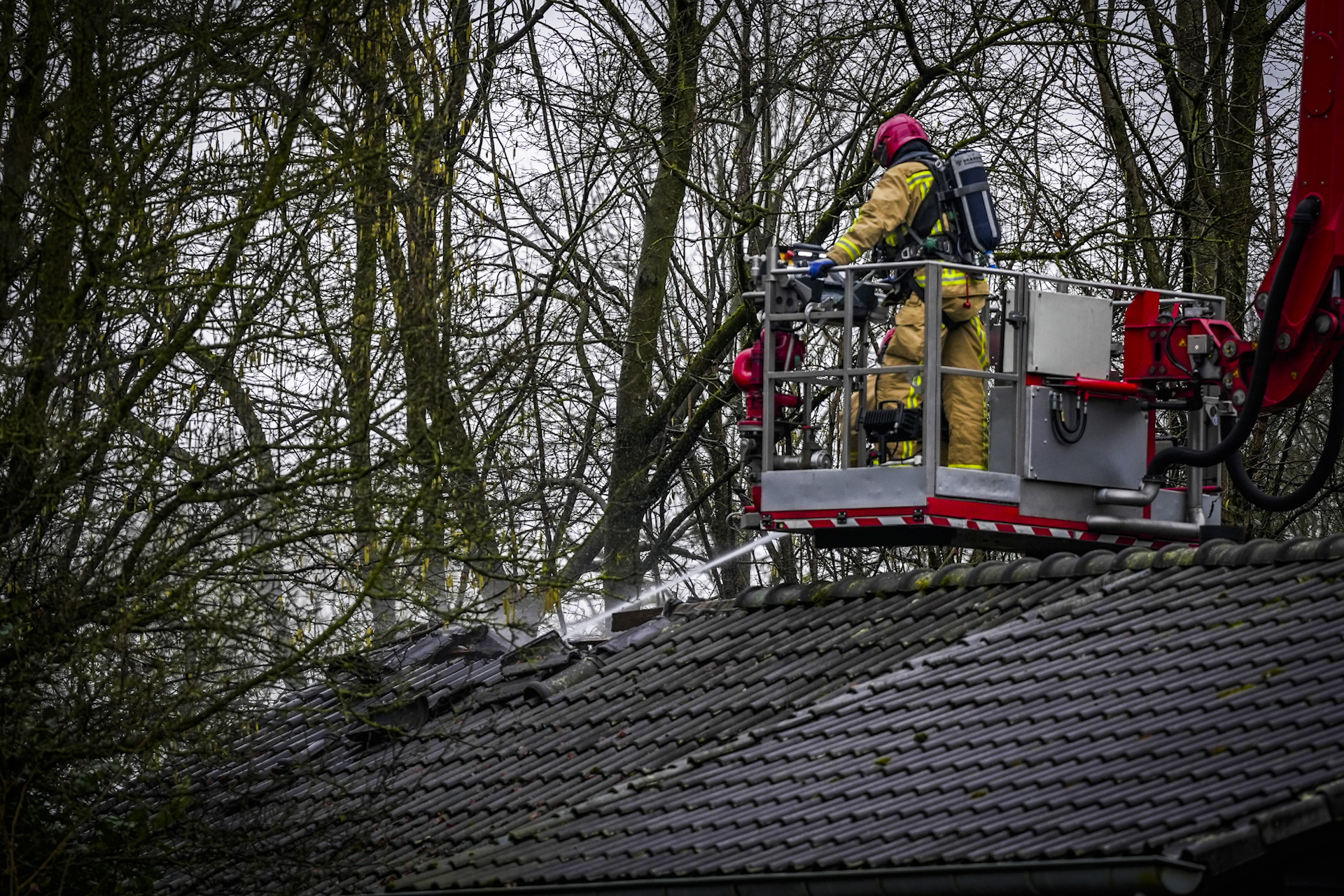 Schoorsteenbrand slaat over na dak van woning