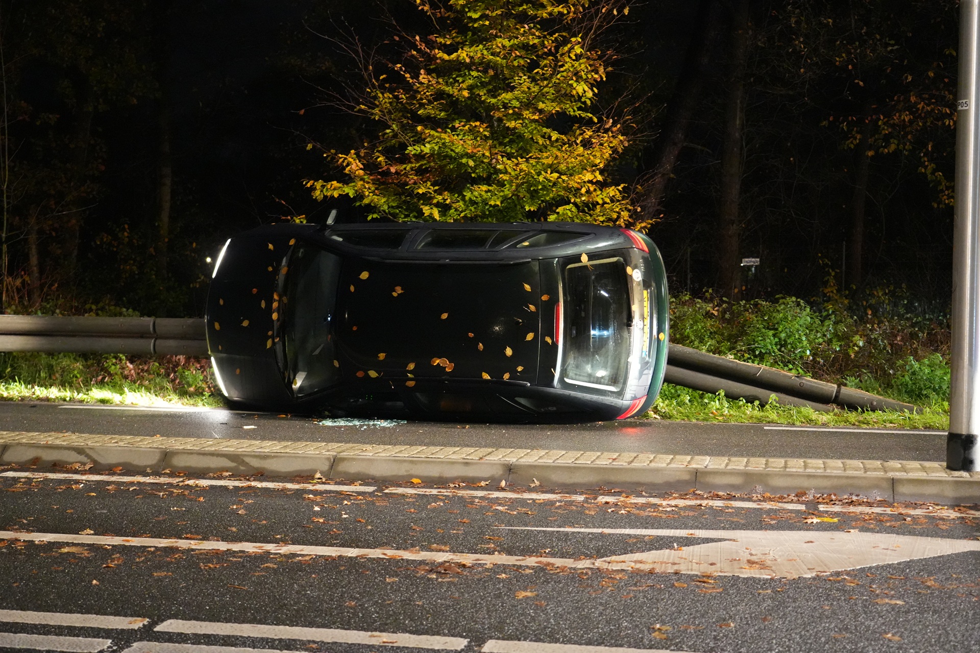 Auto raakt vangrail en belandt op z’n kant