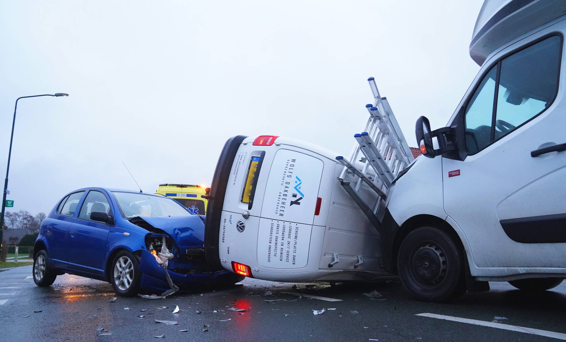 Bestelbus komt op zijn zijkant na ongeluk, bijrijder gewond