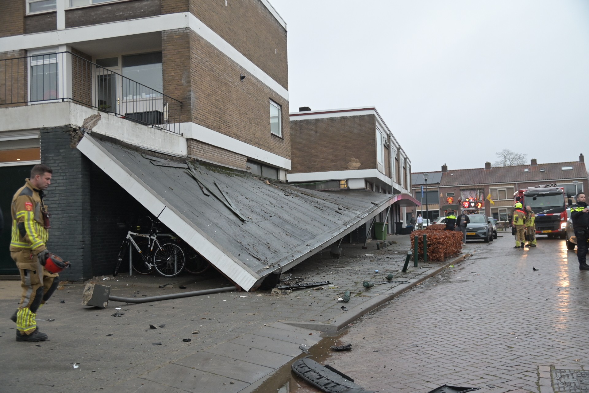 Auto ramt luifel nadat bestuurder over stoep rijdt, luifel ingestort